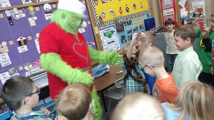 The Grinch visits 1st grade classrooms.